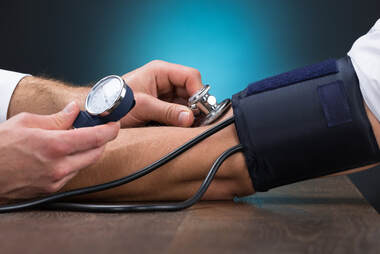 Doctor measuring a patient's blood pressure Picture