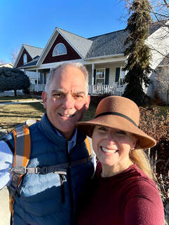 Coach Elizabeth and Doctor Dan in front of their home after a long walk Picture